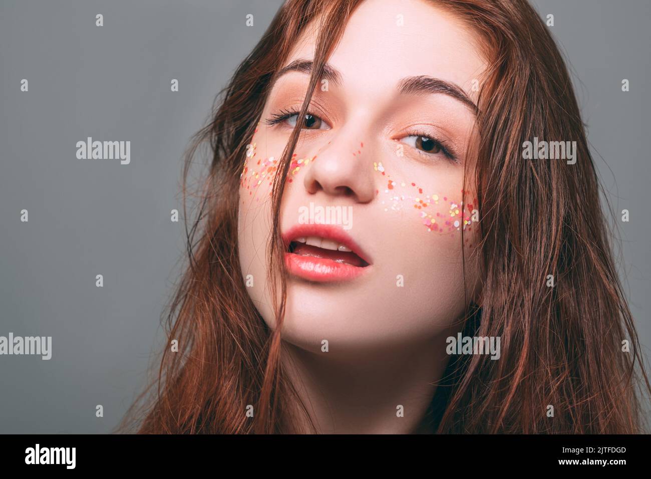 glitter freckles makeup skin youth beauty redhead Stock Photo