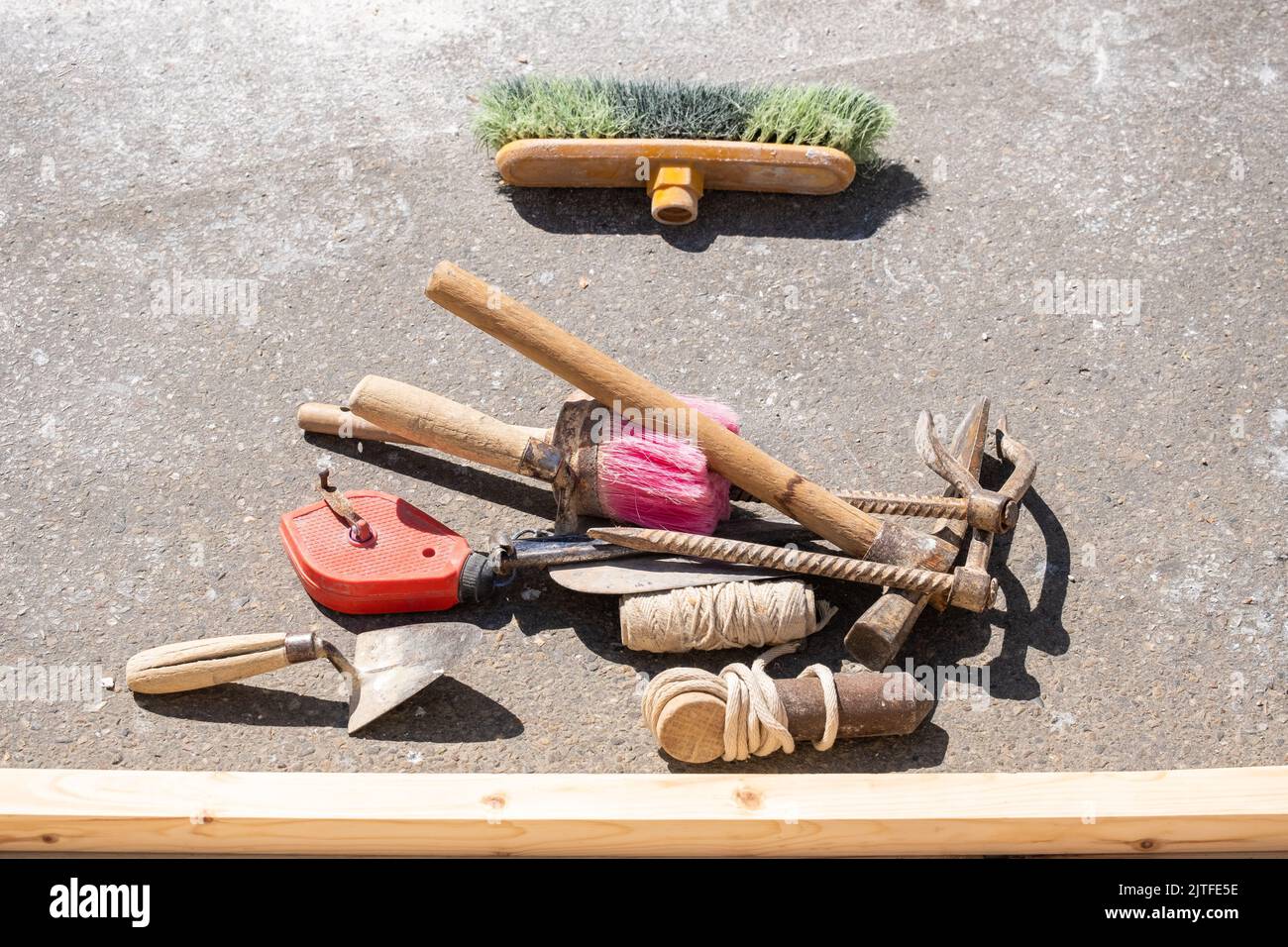 A trowel, a construction drawing, a brush and a plumb line and other