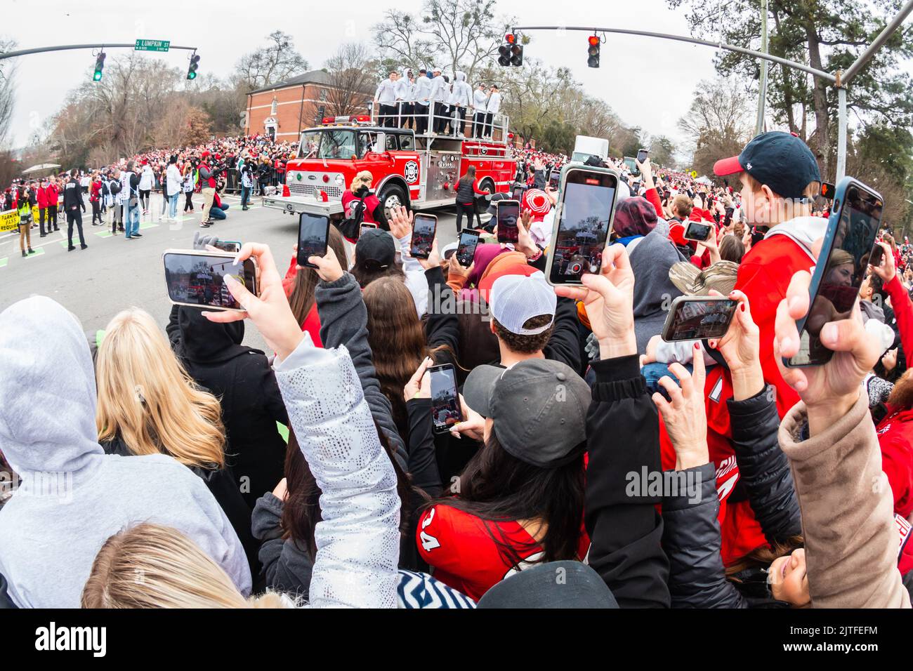 ATHENS, GA - JANUARY 15, 2022: Thousands of football fans cheer on the players as they celebrate Georgia's National Championship victory at a parade. Stock Photo