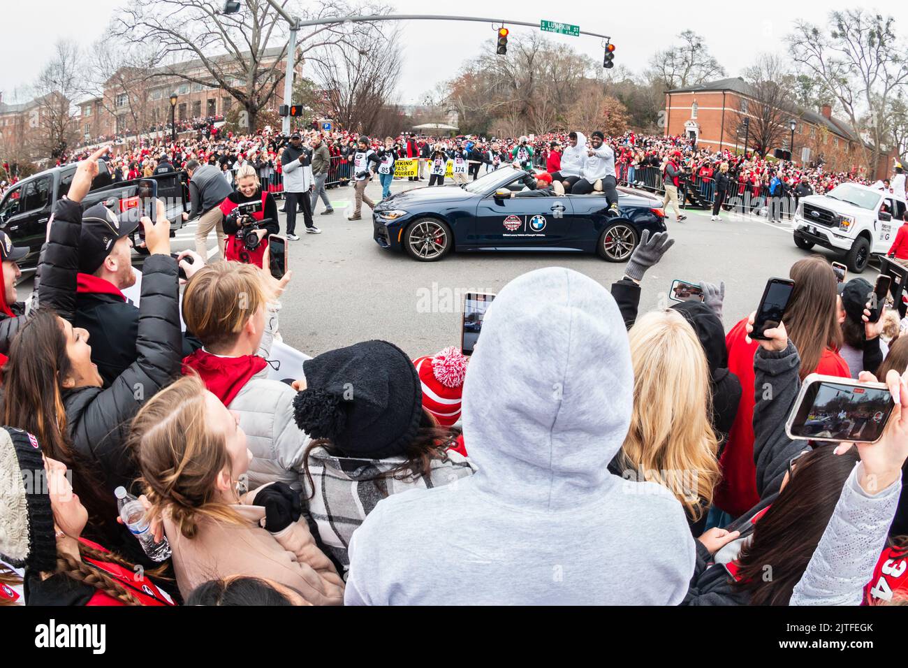 ATHENS, GA - JANUARY 15, 2022: Thousands of UGA football fans cheer on the players as they celebrate at Georgia's National Championship victory parade. Stock Photo