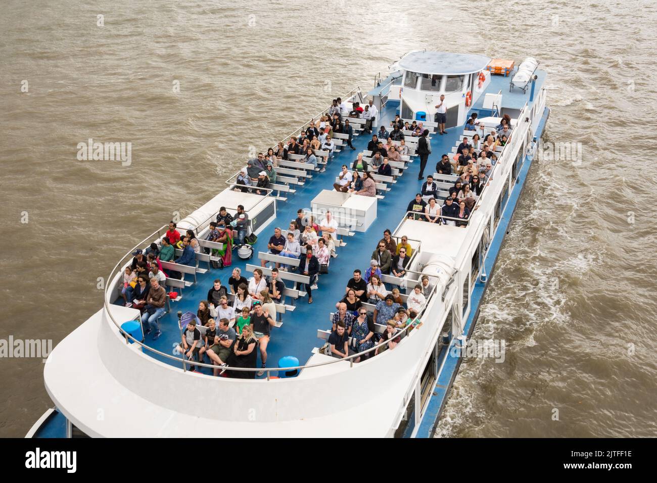 Closeup of tourists aboard a pleasure boat on the River Thames, London, England, UK Stock Photo