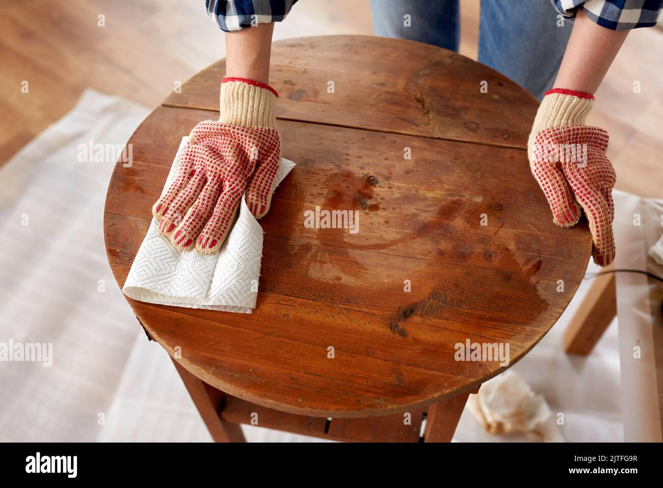 woman cleaning old table surface with paper tissue Stock Photo Alamy