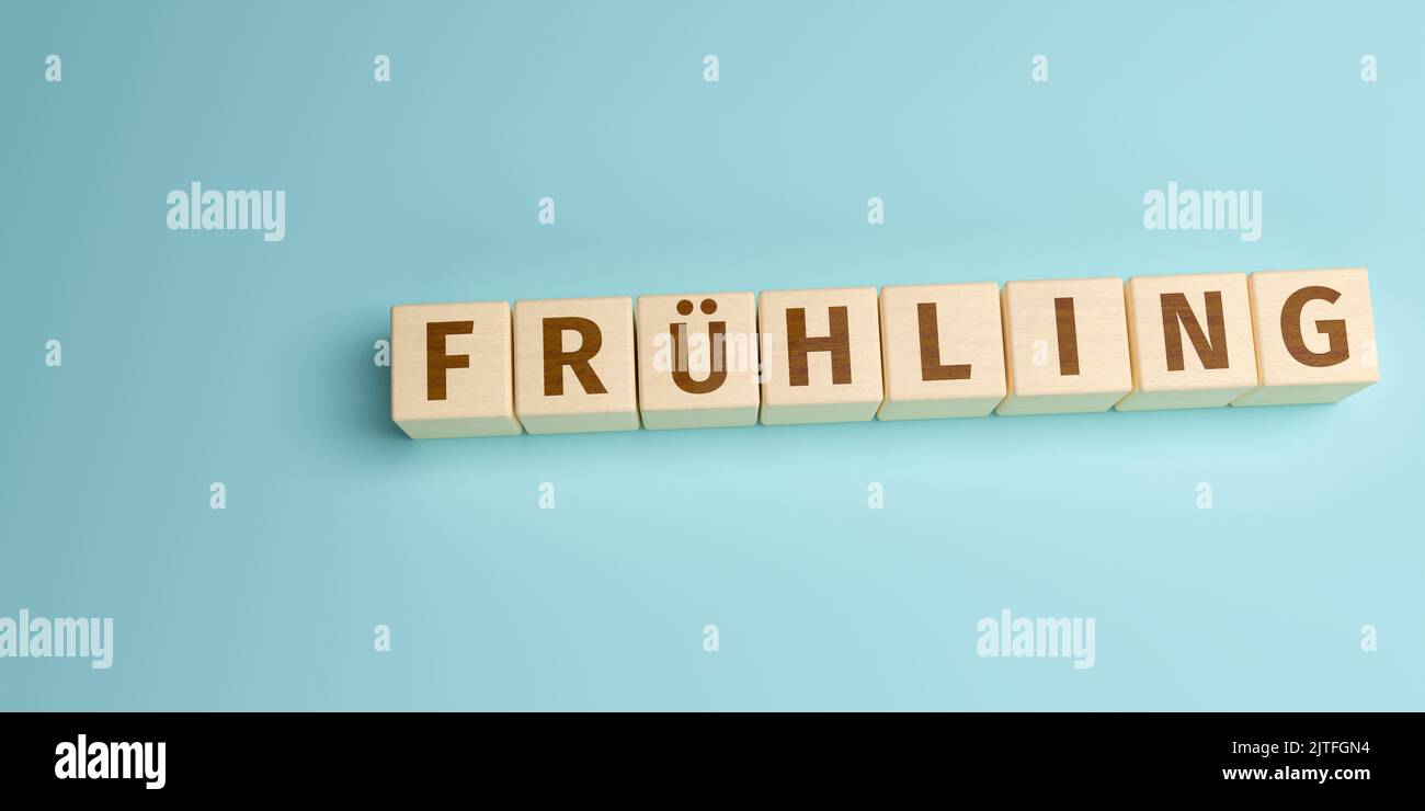 The German word Frühling (Spring) built from letters on wooden cubes. High angle view with copy space Stock Photo