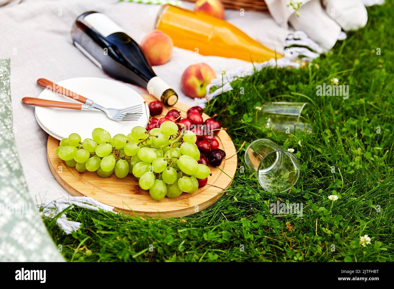 food, drinks and basket on picnic blanket on grass Stock Photo Alamy