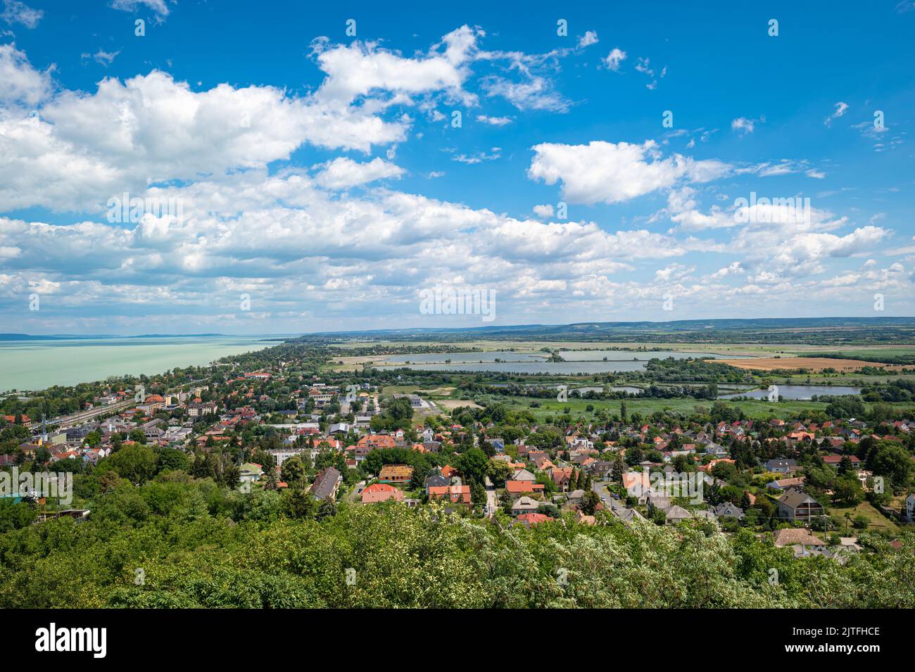 View in northeasterly direction from a watchtower on hill 'Sipos Hegy'. Visible is the town of Fonyód and the shore of Lake Balaton in Hungary. Stock Photo