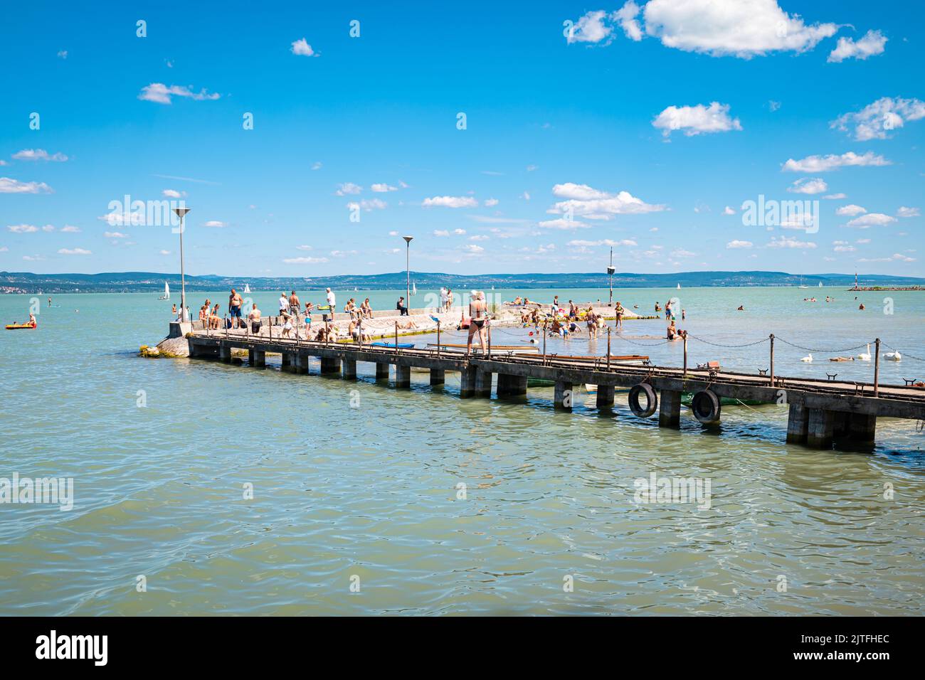 Wooden jetty with tourists at Lake Balaton, Hungary Stock Photo
