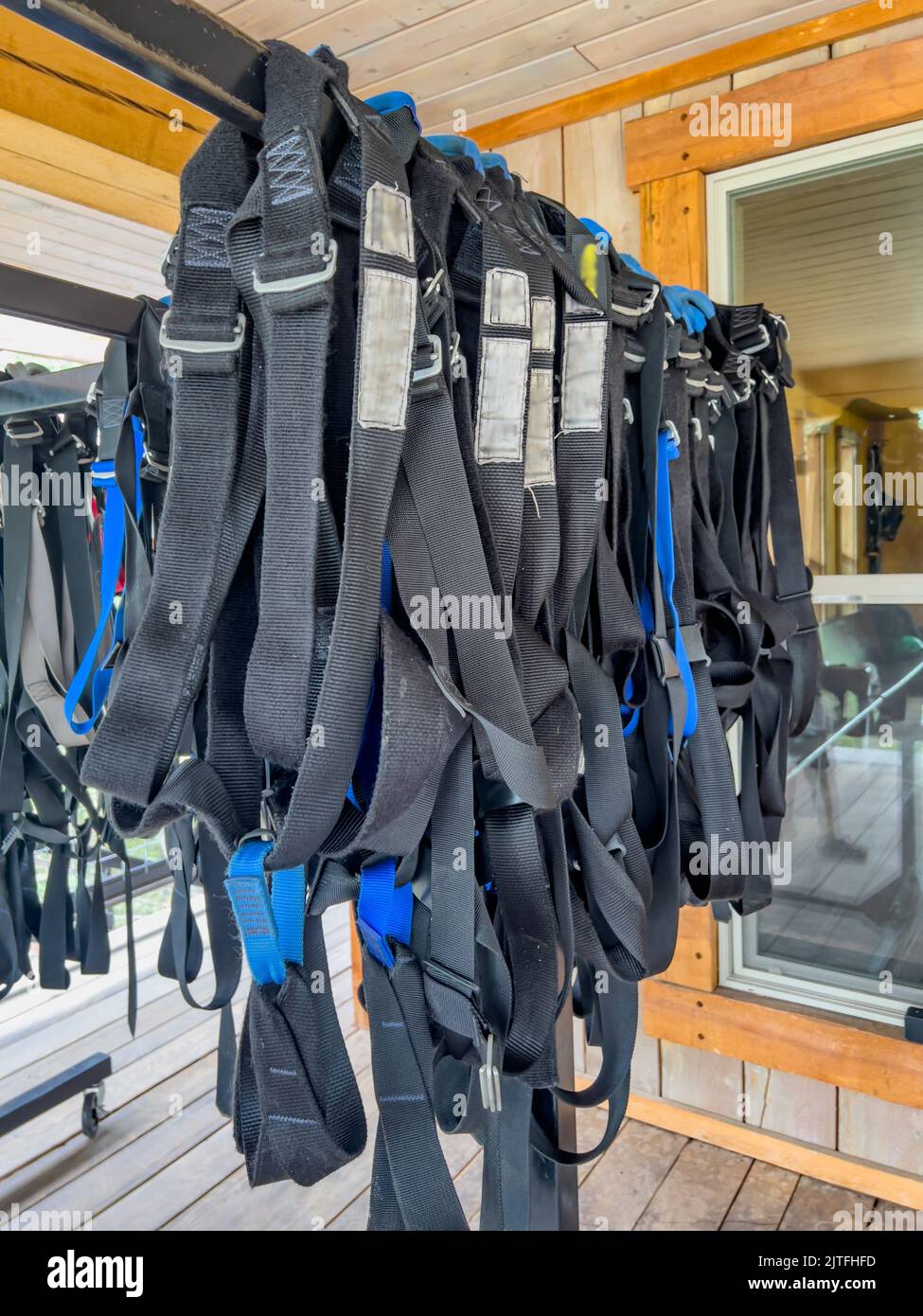 Row of harnesses ready for use at a high ropes and climbing course