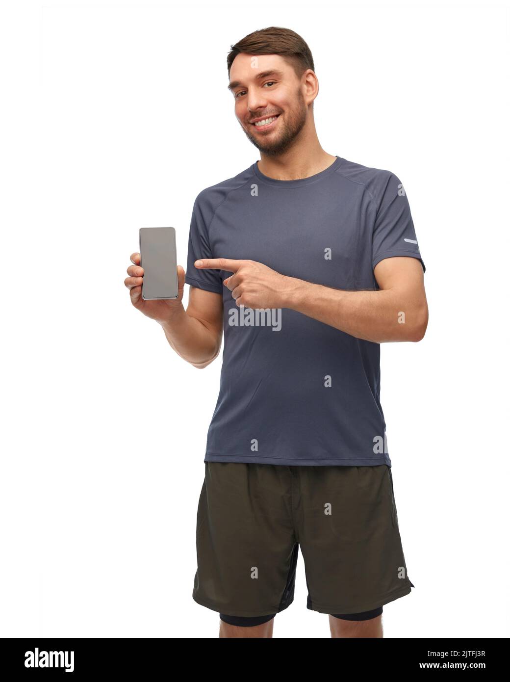 smiling man in sports clothes showing smartphone Stock Photo Alamy