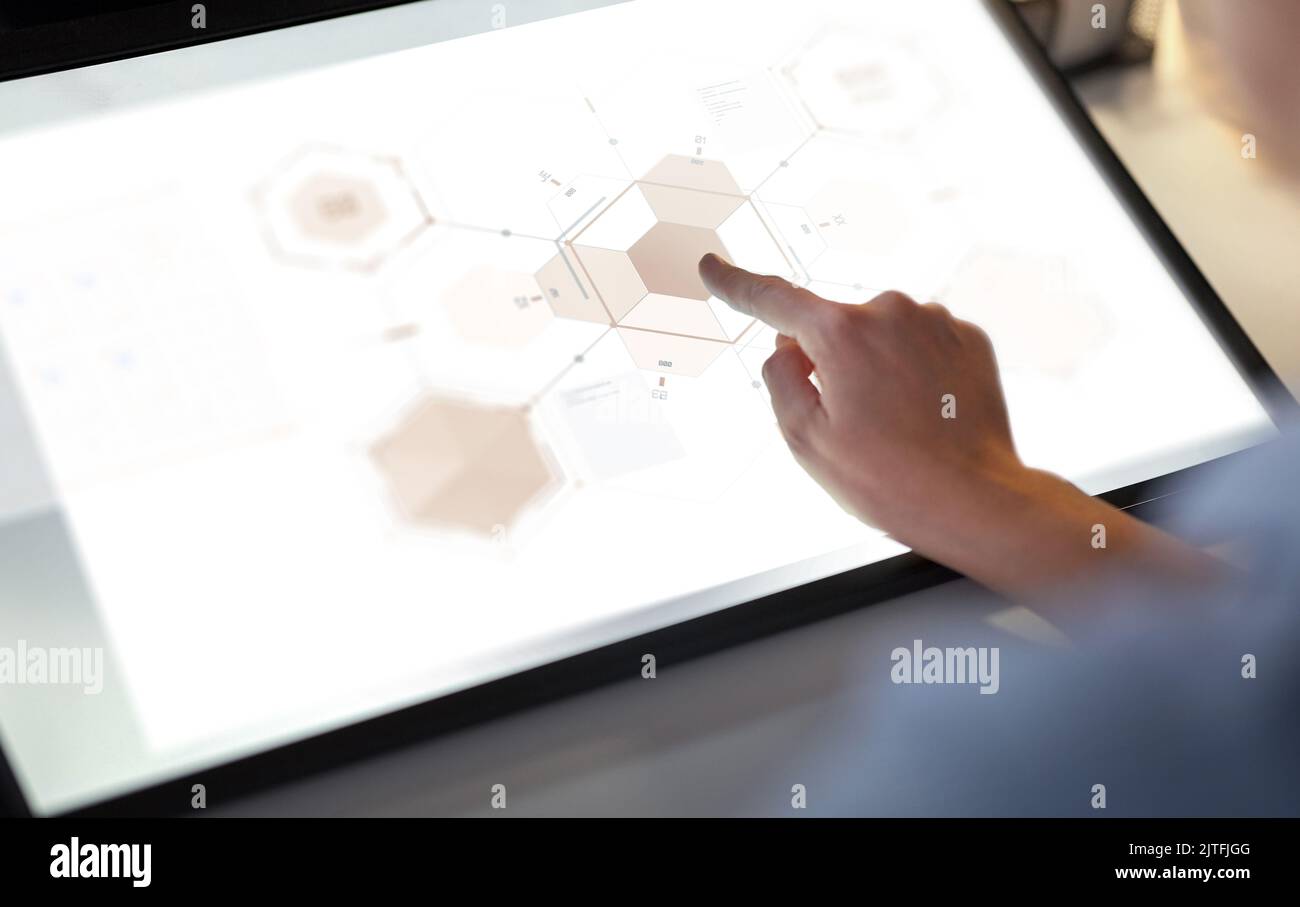 hands on led light tablet at night office Stock Photo