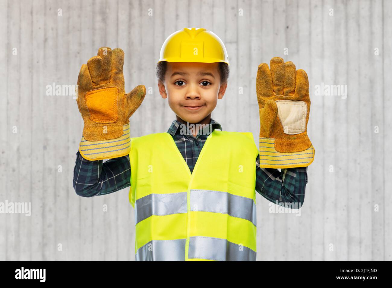 little boy in gloves, safety vest and helmet Stock Photo Alamy