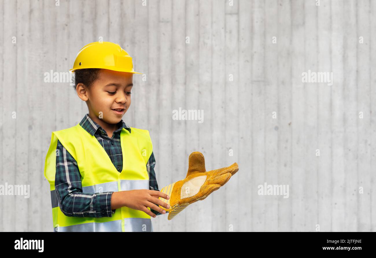 little boy with glove in safety vest and helmet Stock Photo Alamy
