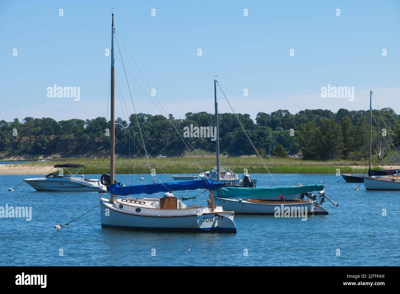 A catboat at it's mooring in Round Cove, Harwich, Massachusetts, on Cape Cod, USA Stock Photo