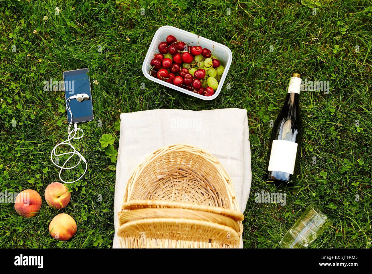 picnic basket, food, drinks and phone on grass Stock Photo Alamy