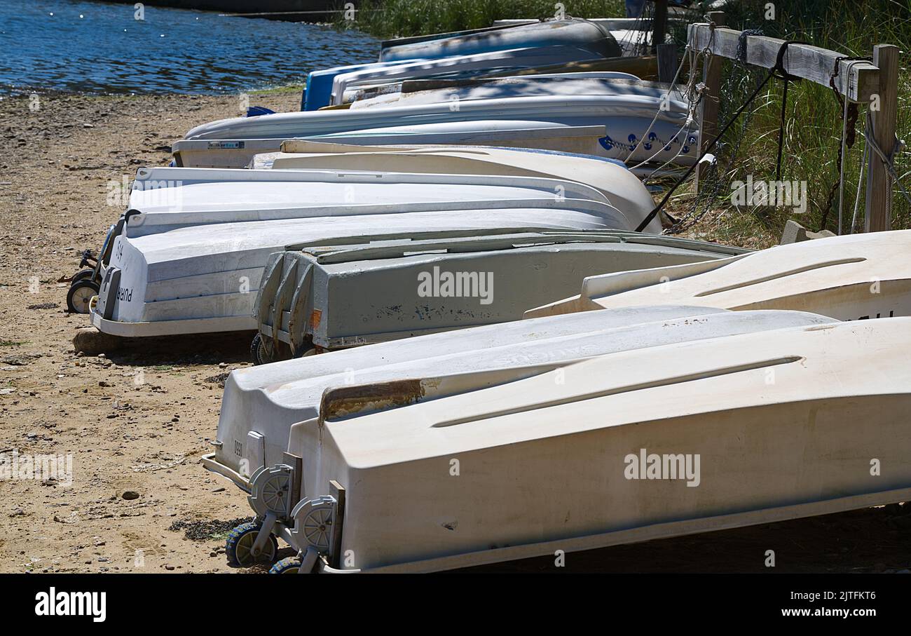 Rowboats (tenders) at rest on Round Cove, Harwich, Massachusetts, on Cape Cod, USA Stock Photo