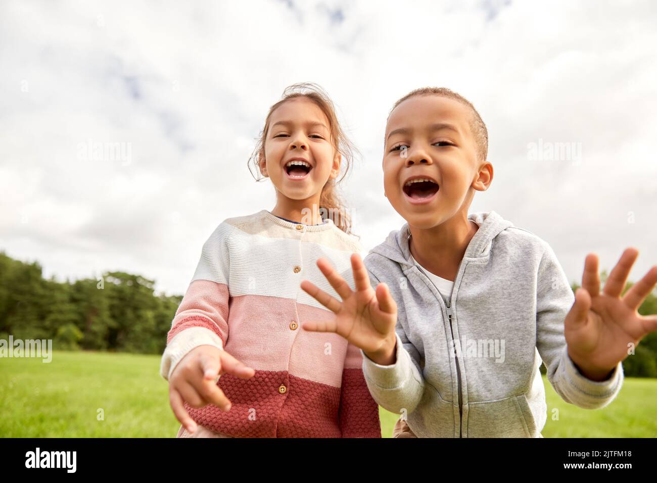 happy little boy and girl at park Stock Photo - Alamy