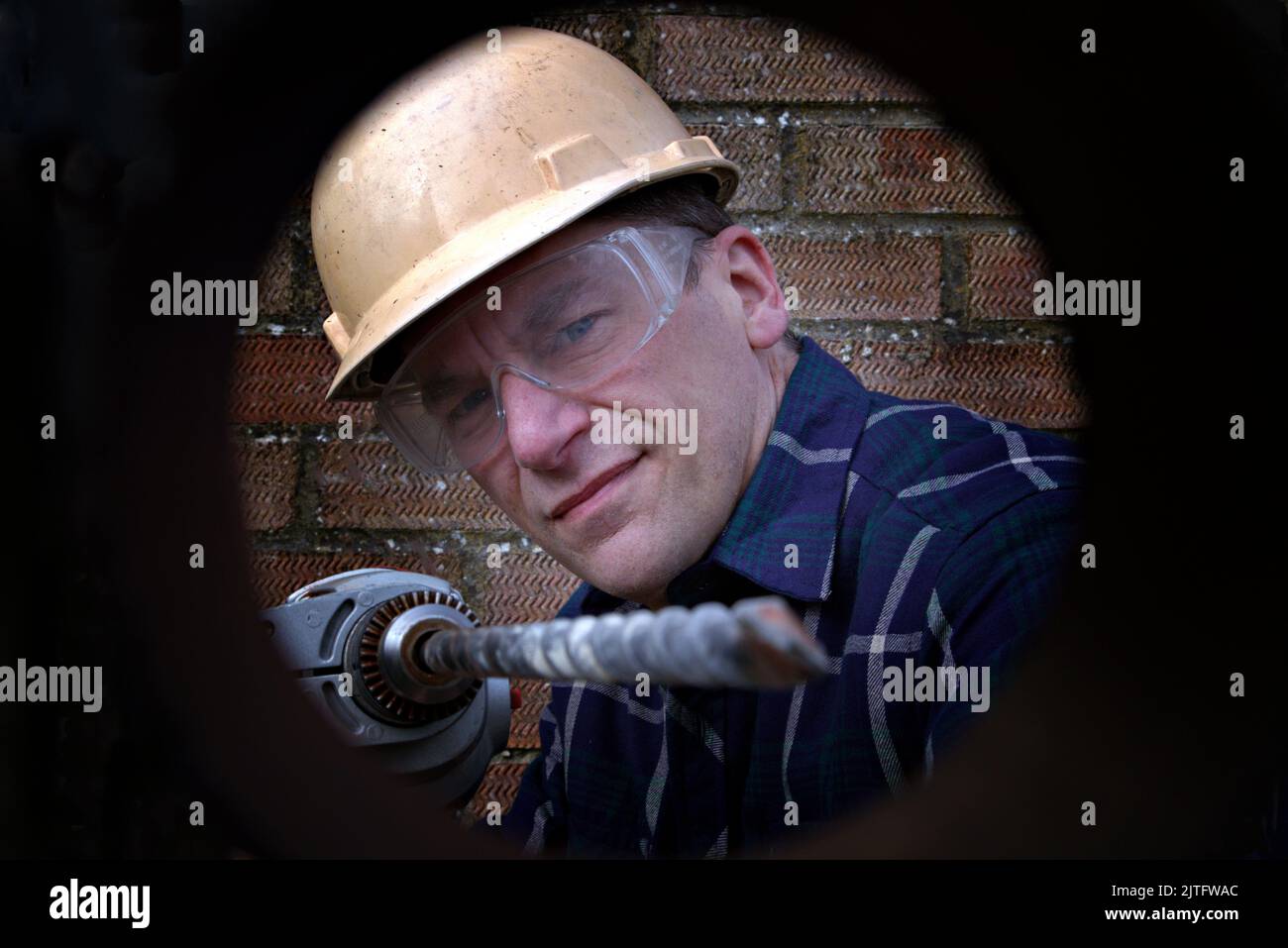 Man drilling a hole Stock Photo