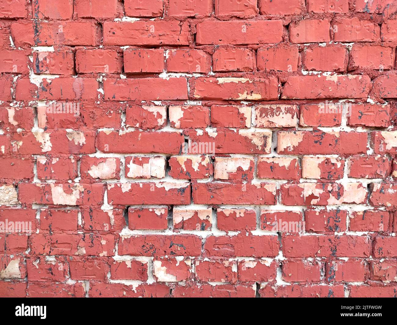 Colorful red brick wall on the house. Texture of red stone blocks, close up. Background. Old building. Stock Photo