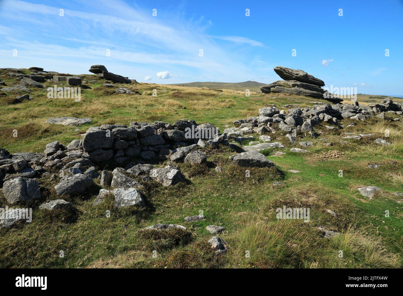 Irishman;s wall and the Logan stone on Belstone tor, Dartmoor, Devon, England, UK Stock Photo