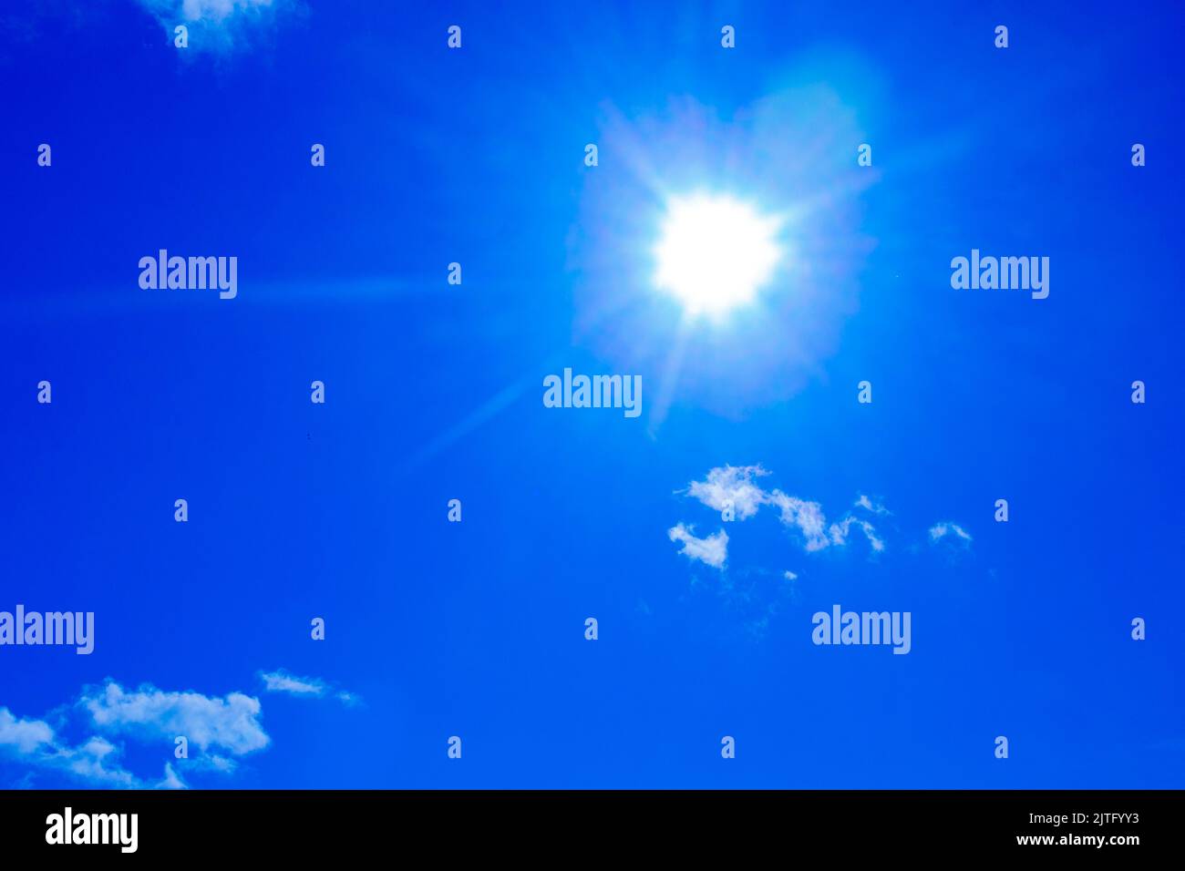 Landscape of the blue bright sky with the white sun and cumulus clouds ...