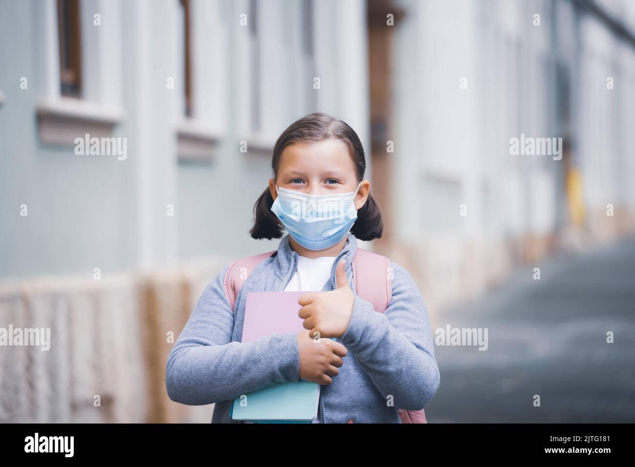 Child with face mask going back to school Stock Photo - Alamy