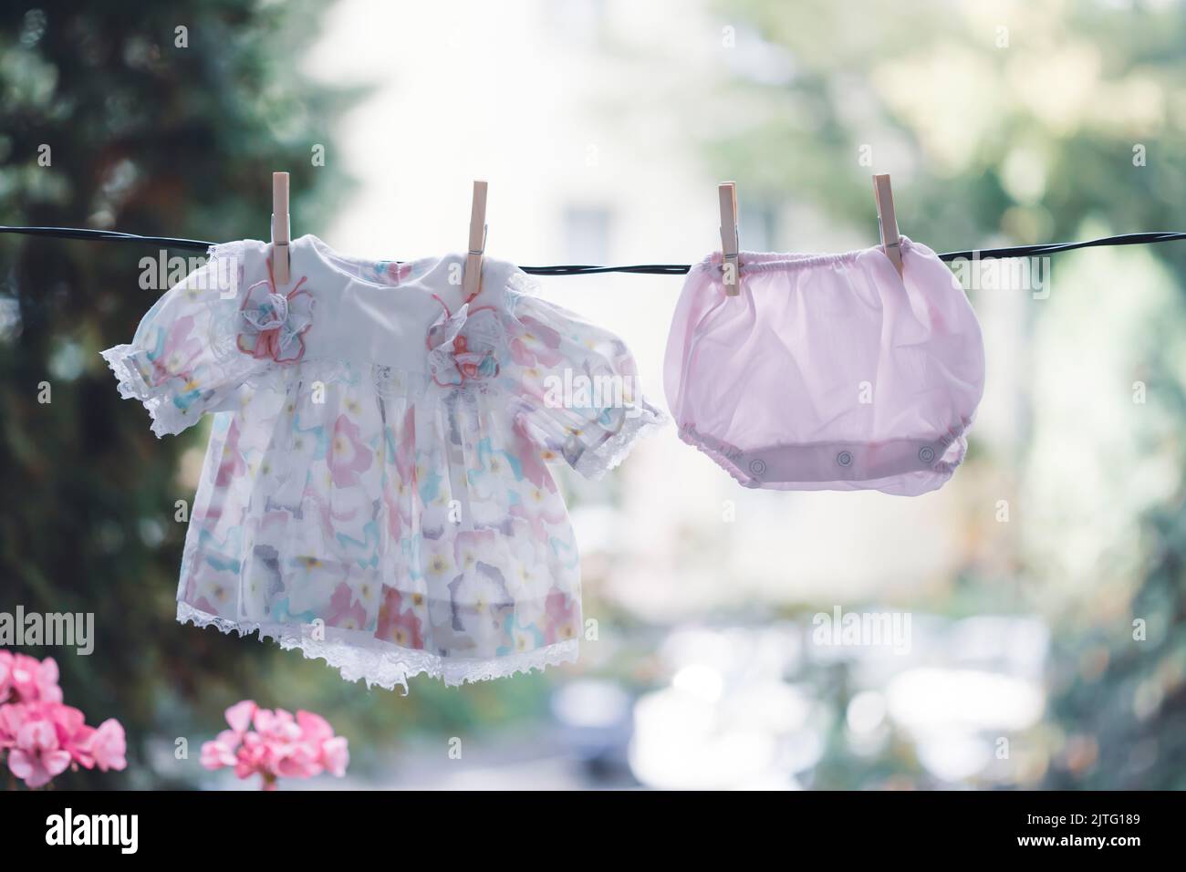 Cute baby girl clothes hanging on the clothesline Stock Photo Alamy