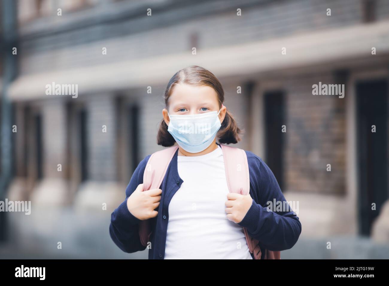Child with face mask going back to school Stock Photo - Alamy