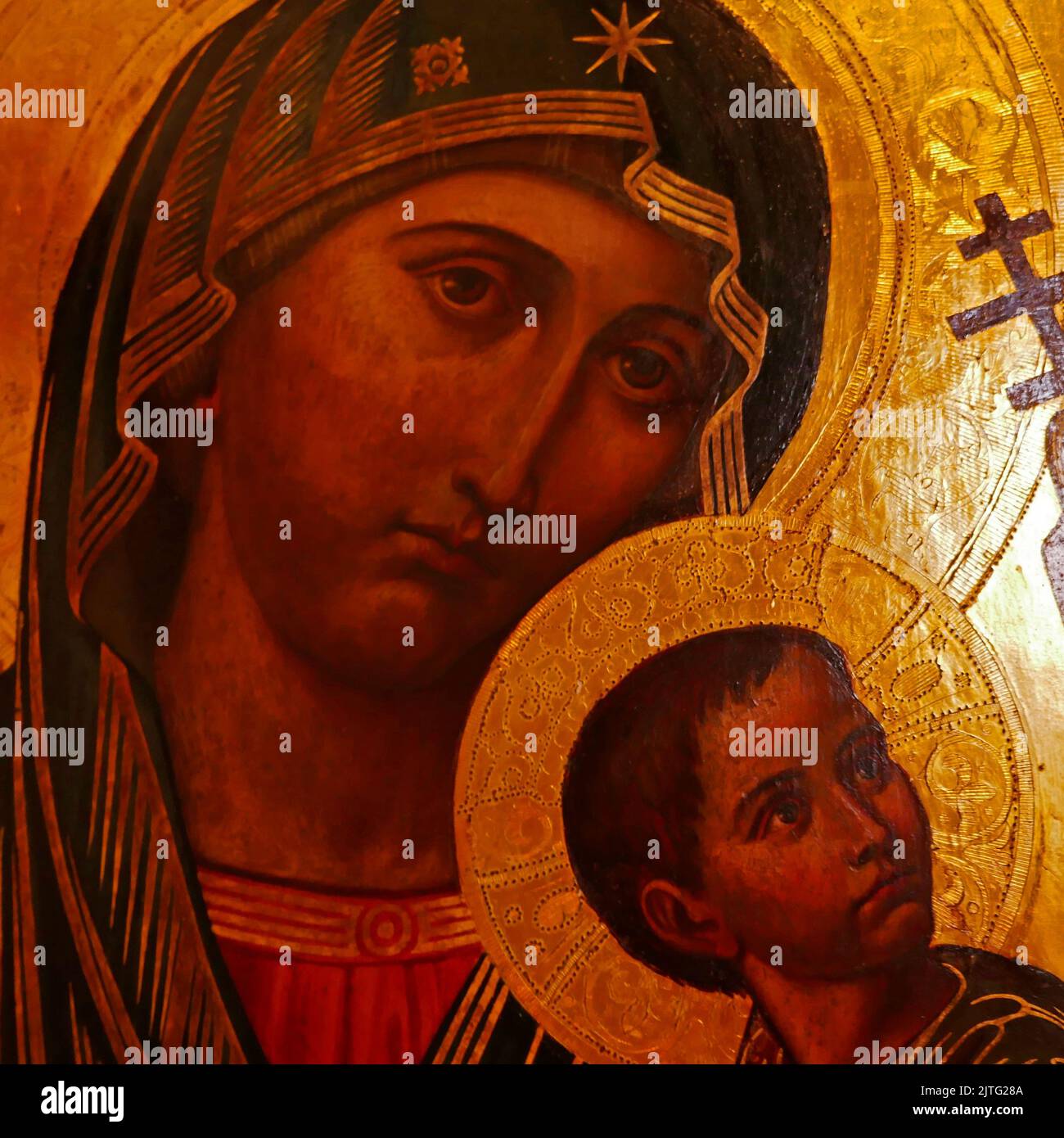 Rheine, NRW, Germany - August 24 2022 Art in the St. Dionysius church. Icon of mother Mary and child Jesus with gold colored background. Detail of the Stock Photo