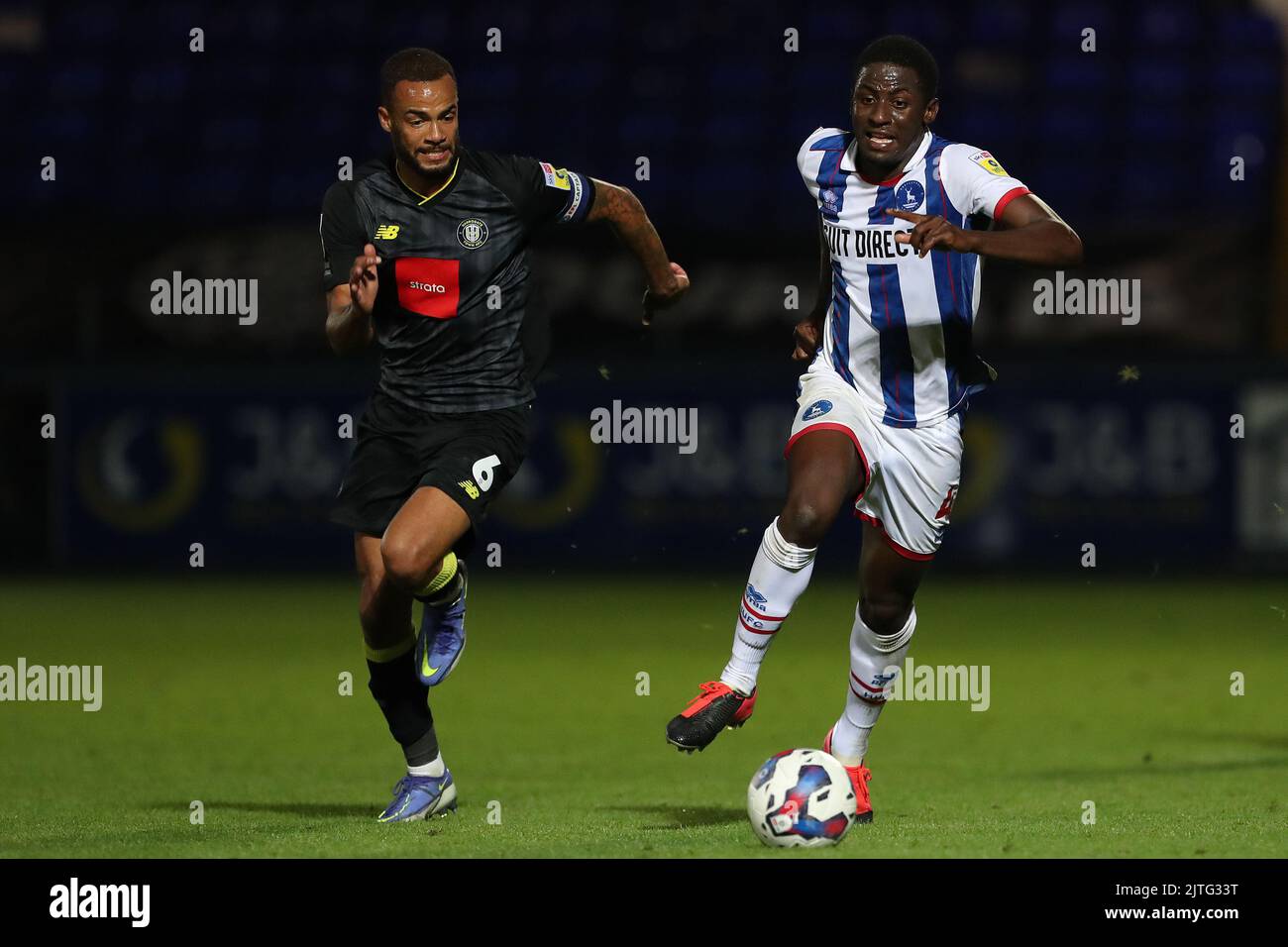 Hartlepool United's Mouhamed Niang gets away from Harrogate Town's Warren Burrell during the Papa John's EFL Trophy match between Hartlepool United and Harrogate Town at Victoria Park, Hartlepool on Tuesday 30th August 2022. (Credit: Mark Fletcher | MI News) Credit: MI News & Sport /Alamy Live News Stock Photo