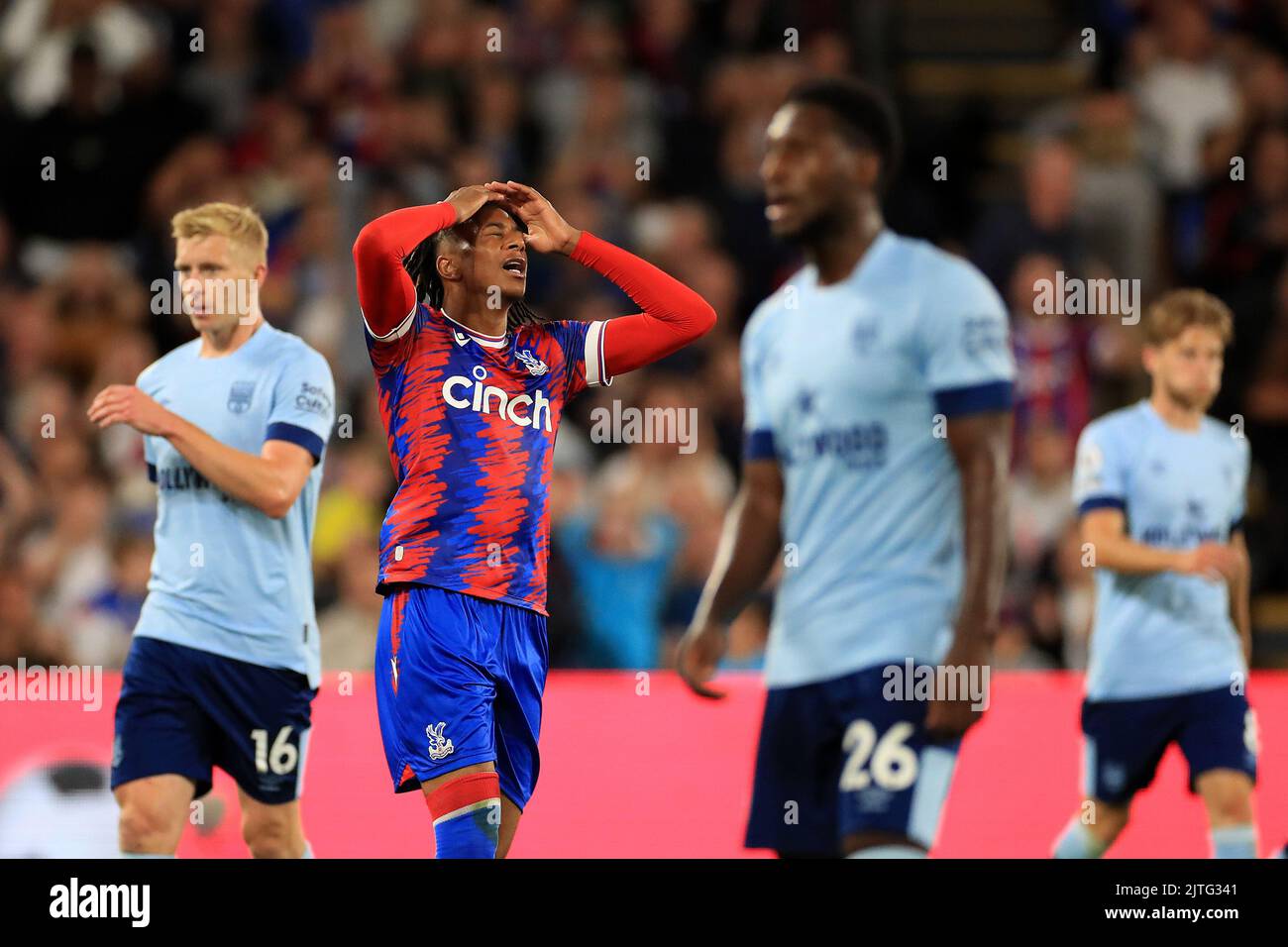 Michael Olise #7 of Crystal Palace sees his shot hit the post