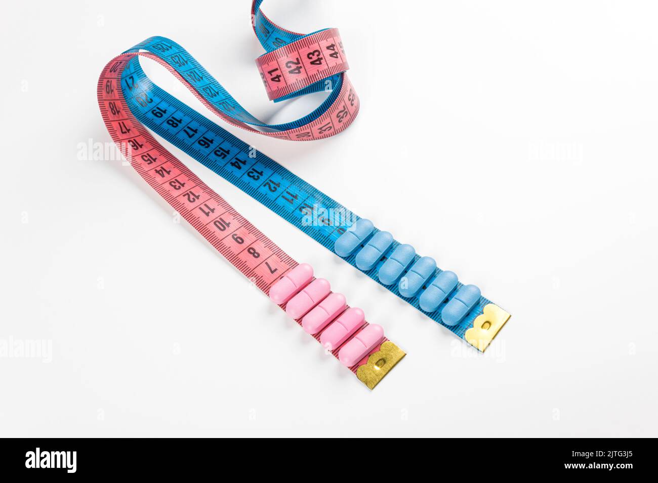 Pink centimeter tape measure on blue background Stock Photo - Alamy