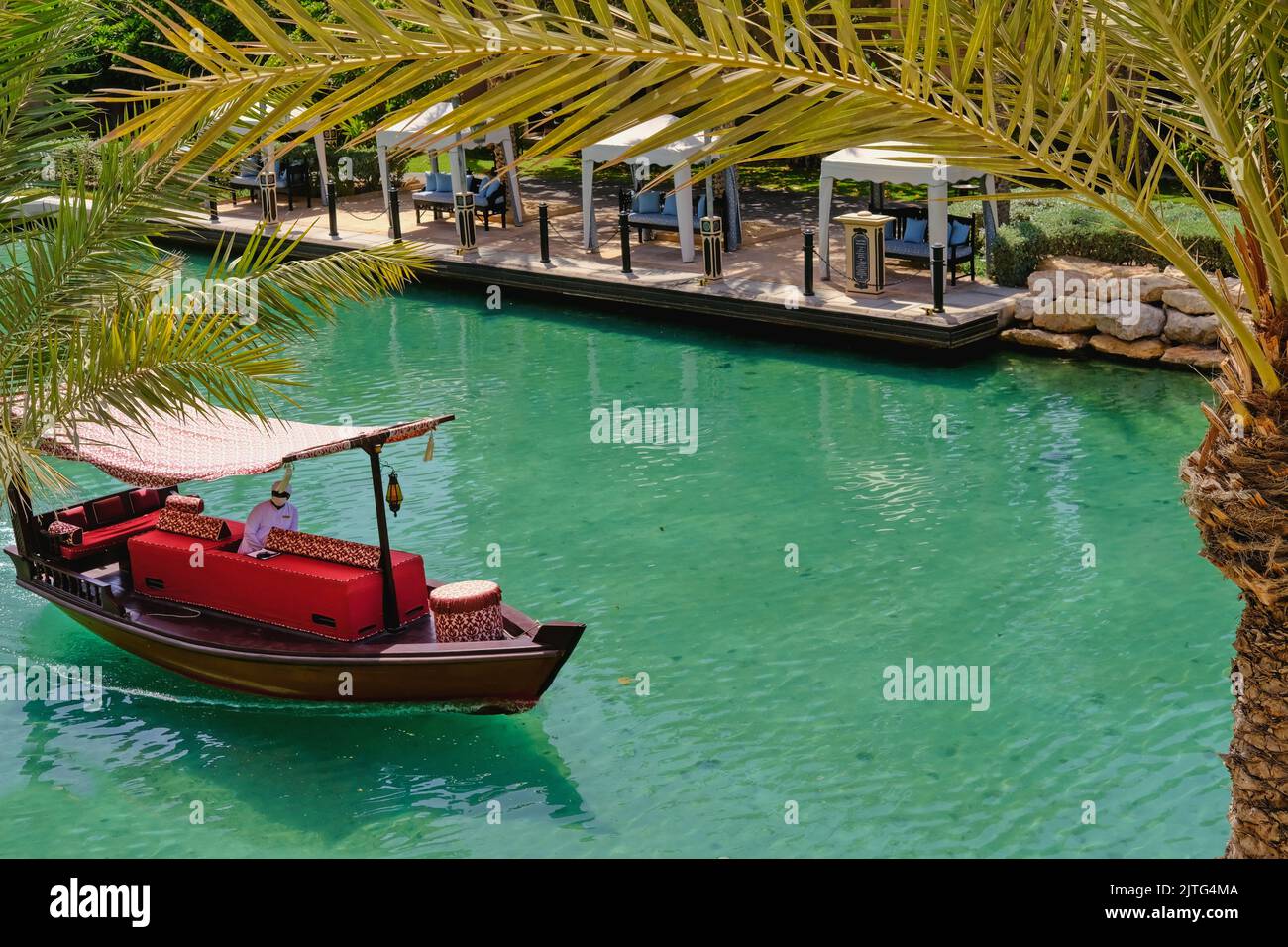 Scenic view of traditional arab abra-boat on turquoise water of Madinat Jumeirah canal. Dubai tourist ferry luxury boat taxi.Dubai,UAE.Aug.2022 Stock Photo
