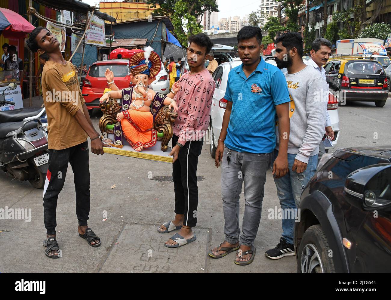 Mumbai, India. 30th Aug, 2022. Devotees pose for a photo holding an idol of elephant headed Hindu god Ganesh ahead of Ganesh Chaturthi. The 10 days festival of Ganesh Chaturthi begins 31st August where devotees pray and seek blessings from the god of wisdom, knowledge and prosperity. Credit: SOPA Images Limited/Alamy Live News Stock Photo