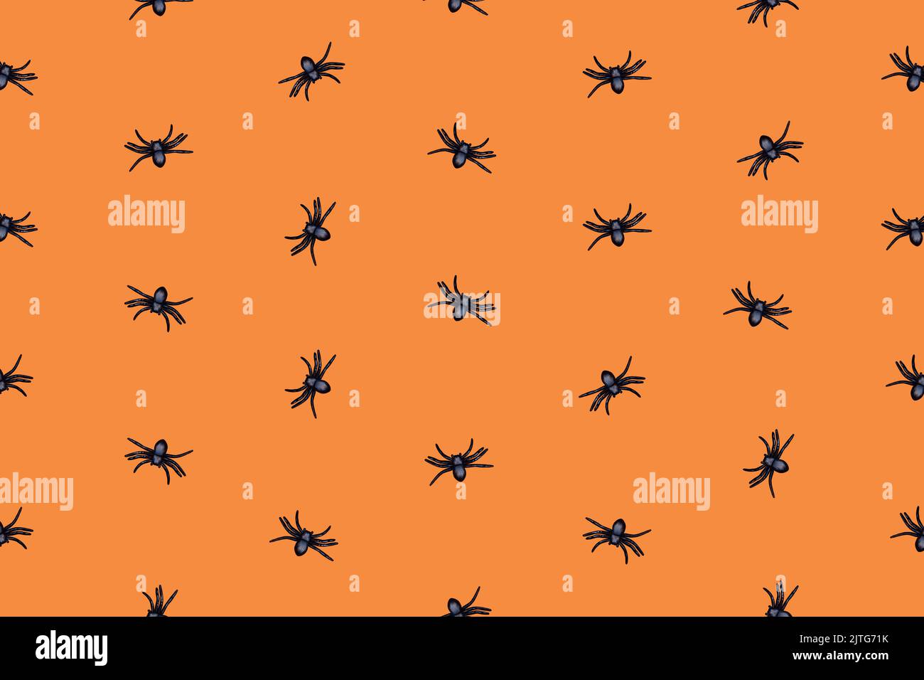 Creepy Halloween pattern with black spiders on orange background ...