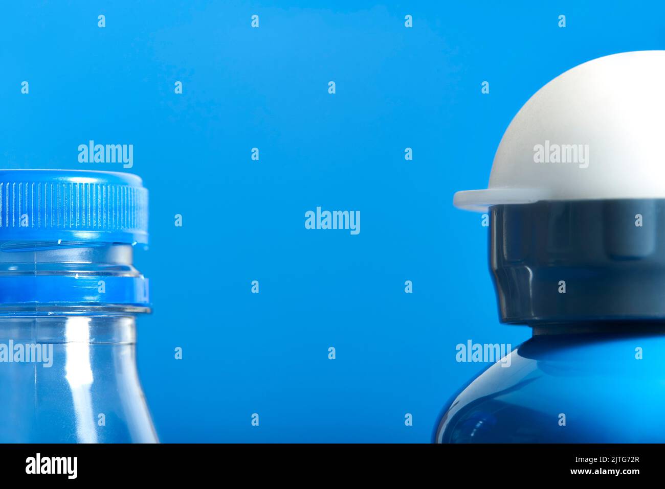 Pair of bottles, a plastic transparent disposable one and a blue metal