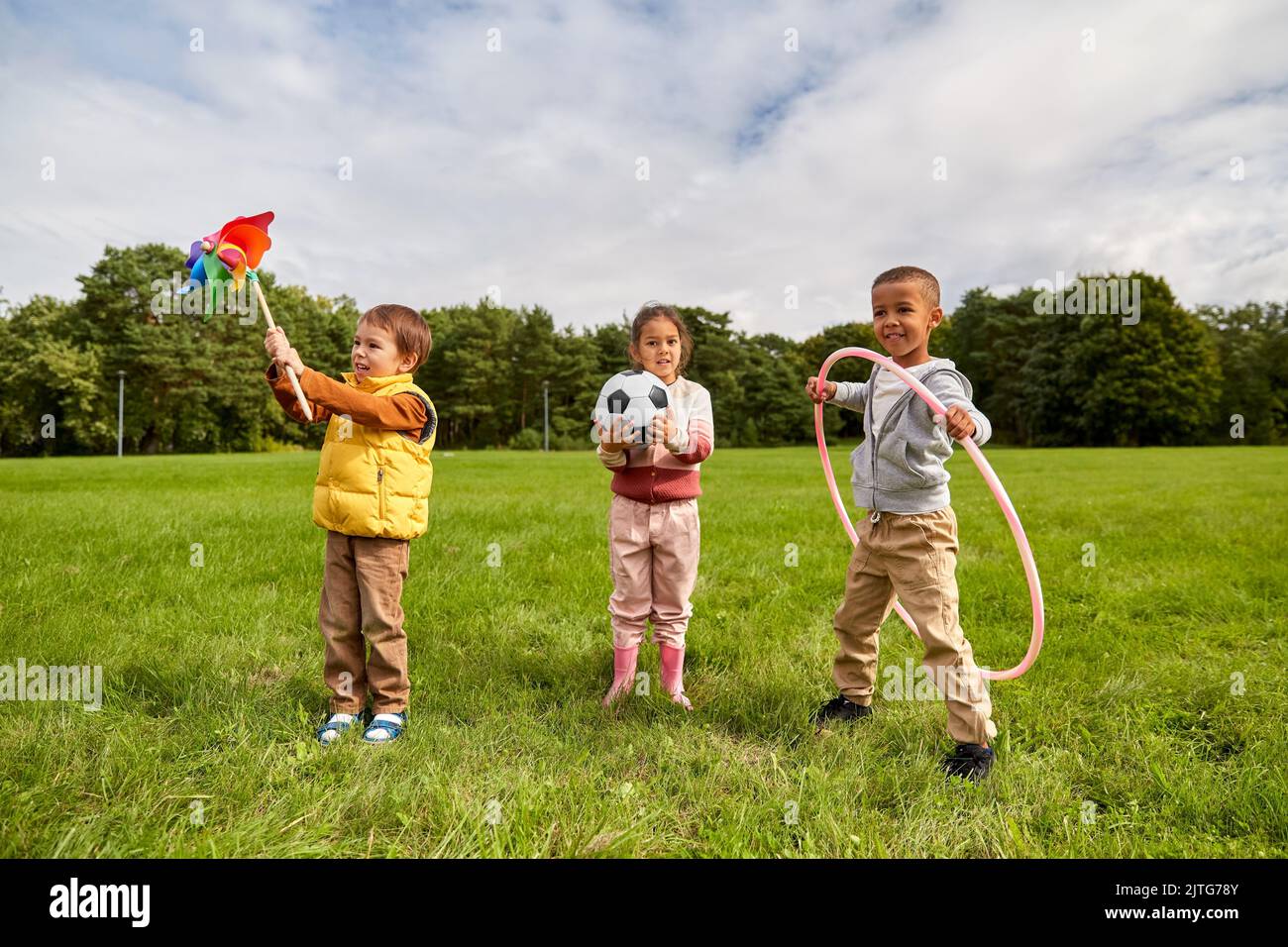 happy children with toys playing at park Stock Photo - Alamy