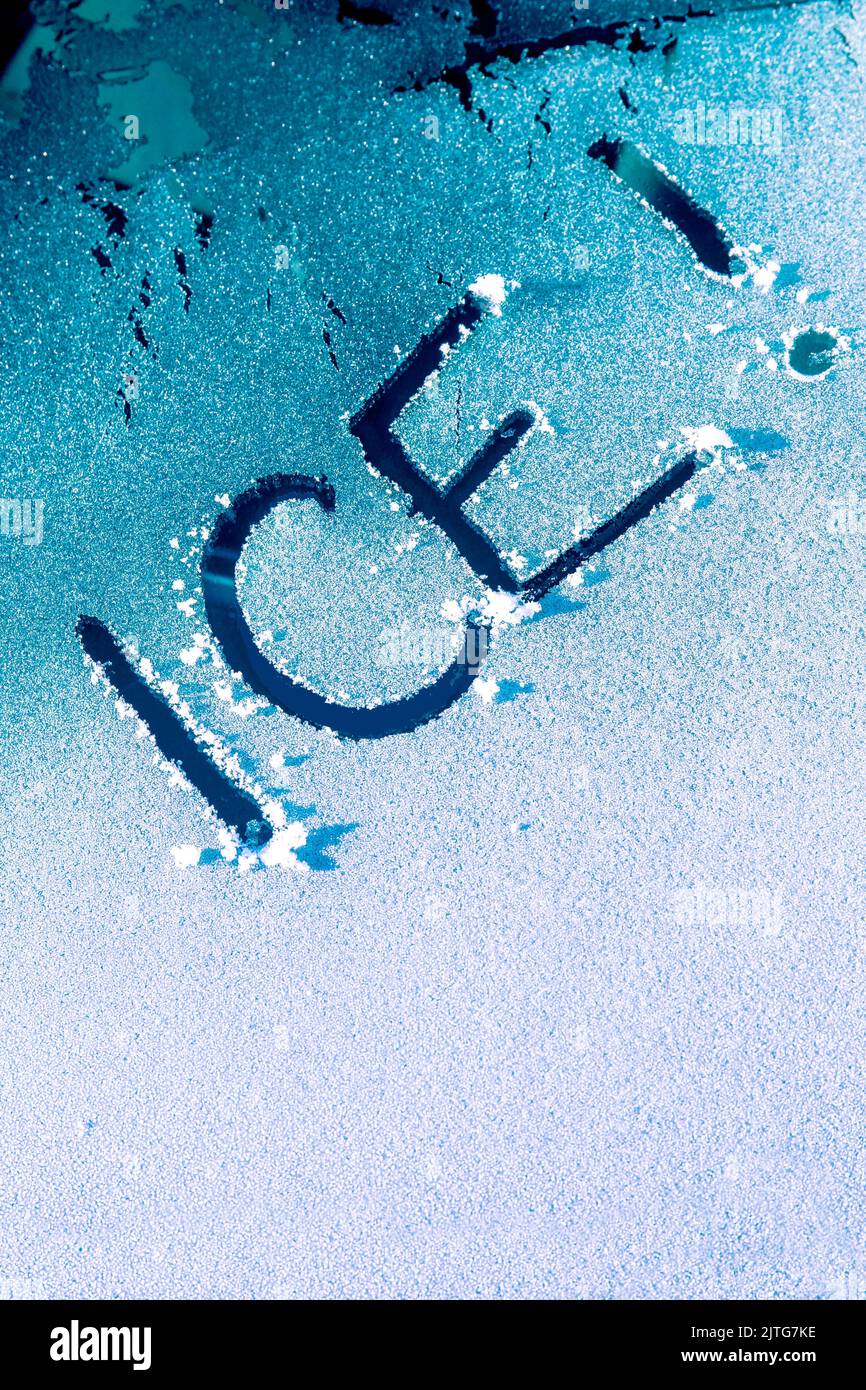 The word Ice scraped onto a car windscreen windshield Stock Photo