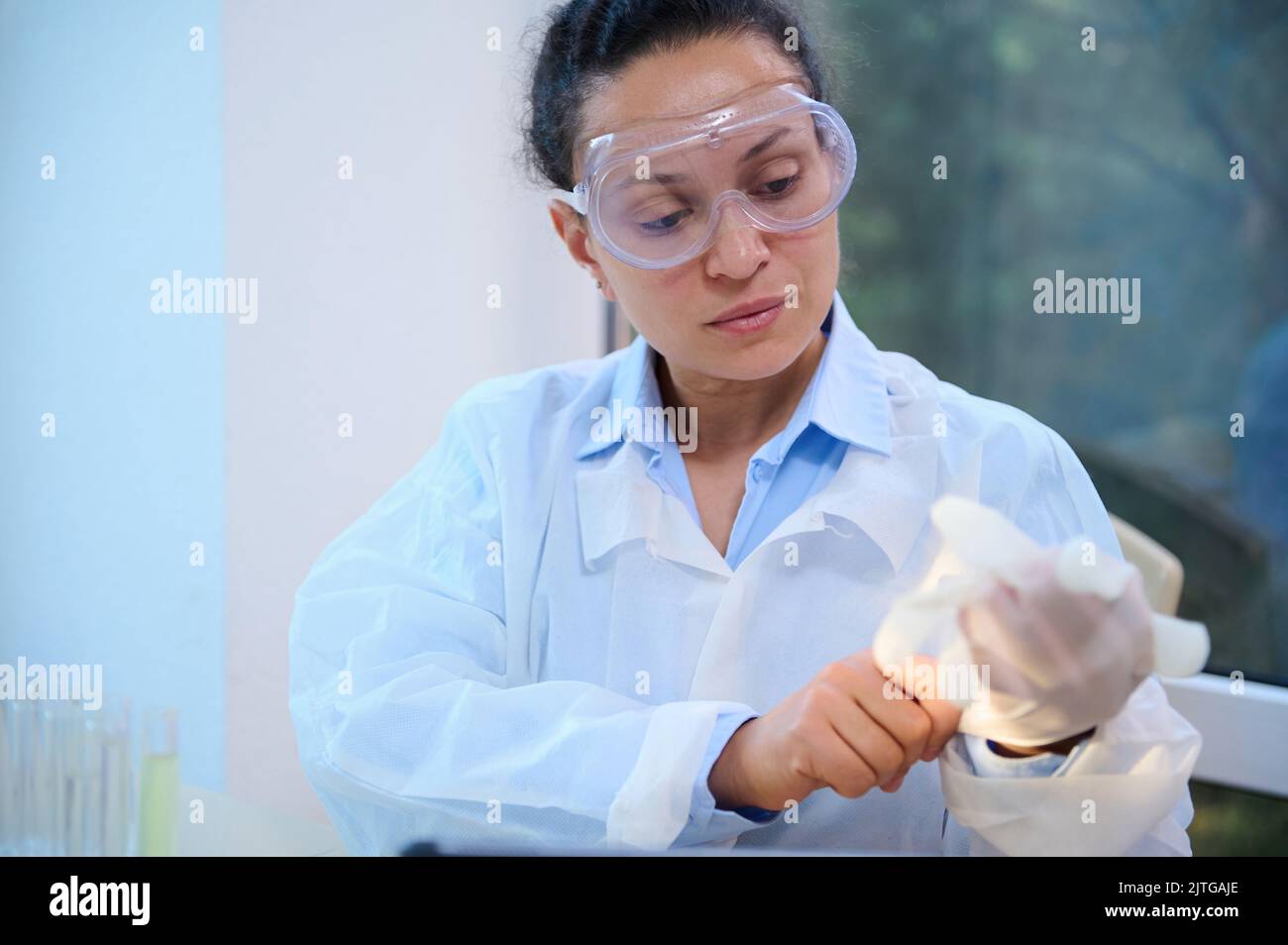 Female scientist, medical laboratory worker in white lab coat and