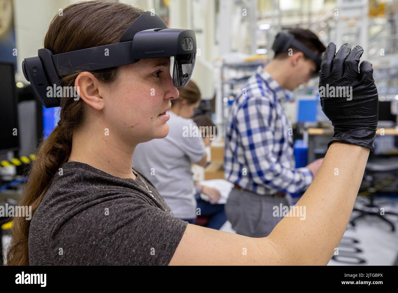 KSC, Florida, USA. 16th Jan, 2020. Mary Lakaszcyck, a technician with ASRC Federal Data Solutions, demonstrates a pair of augmented reality (AR) goggles inside the high bay of the Neil Armstrong Operations and Checkout Building at NASAs Kennedy Space Center in Florida on Jan. 16, 2020. Orion manufacturer Lockheed Martin provided the goggles to technicians to help place tapes where components will be installed on the Orion crew module adapter for NASAs Artemis II mission, the first crewed mission aboard the spacecraft. Using the AR goggles saves significant labor and time to complete tasks. Stock Photo