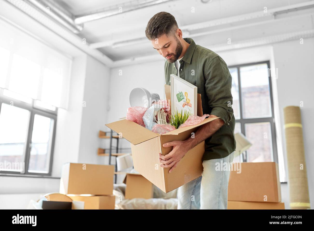 man with boxes moving to new home Stock Photo