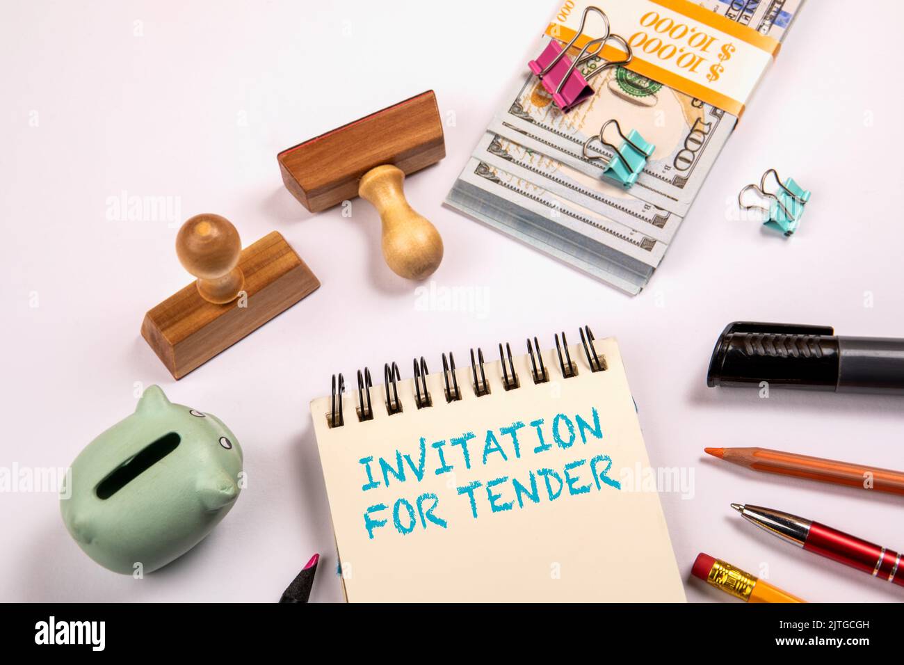 INVITATION FOR TENDER. Money on a white office table. Stock Photo