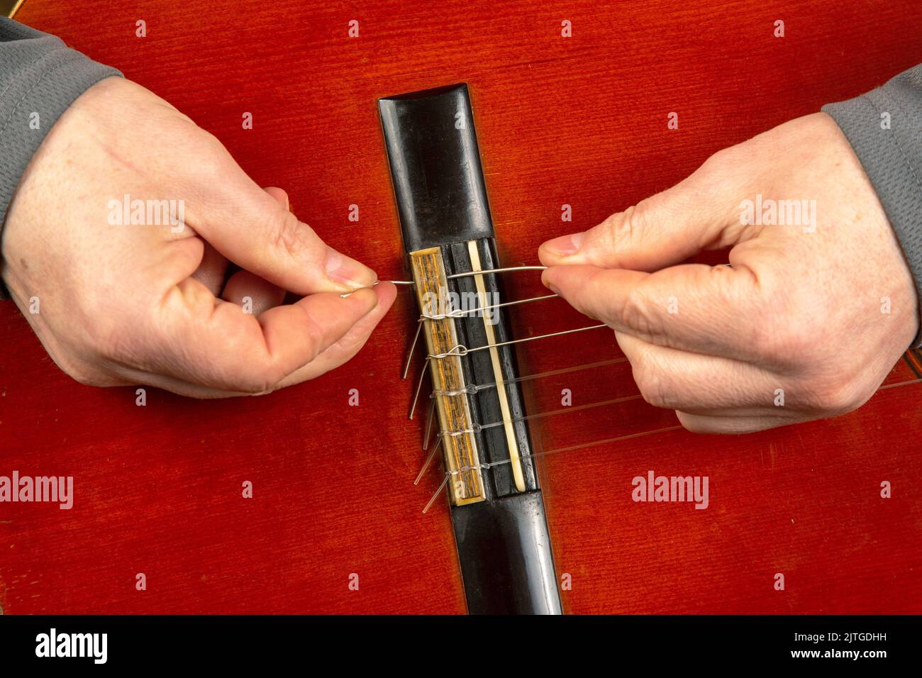 replacement and insertion of nylon strings in a classical guitar