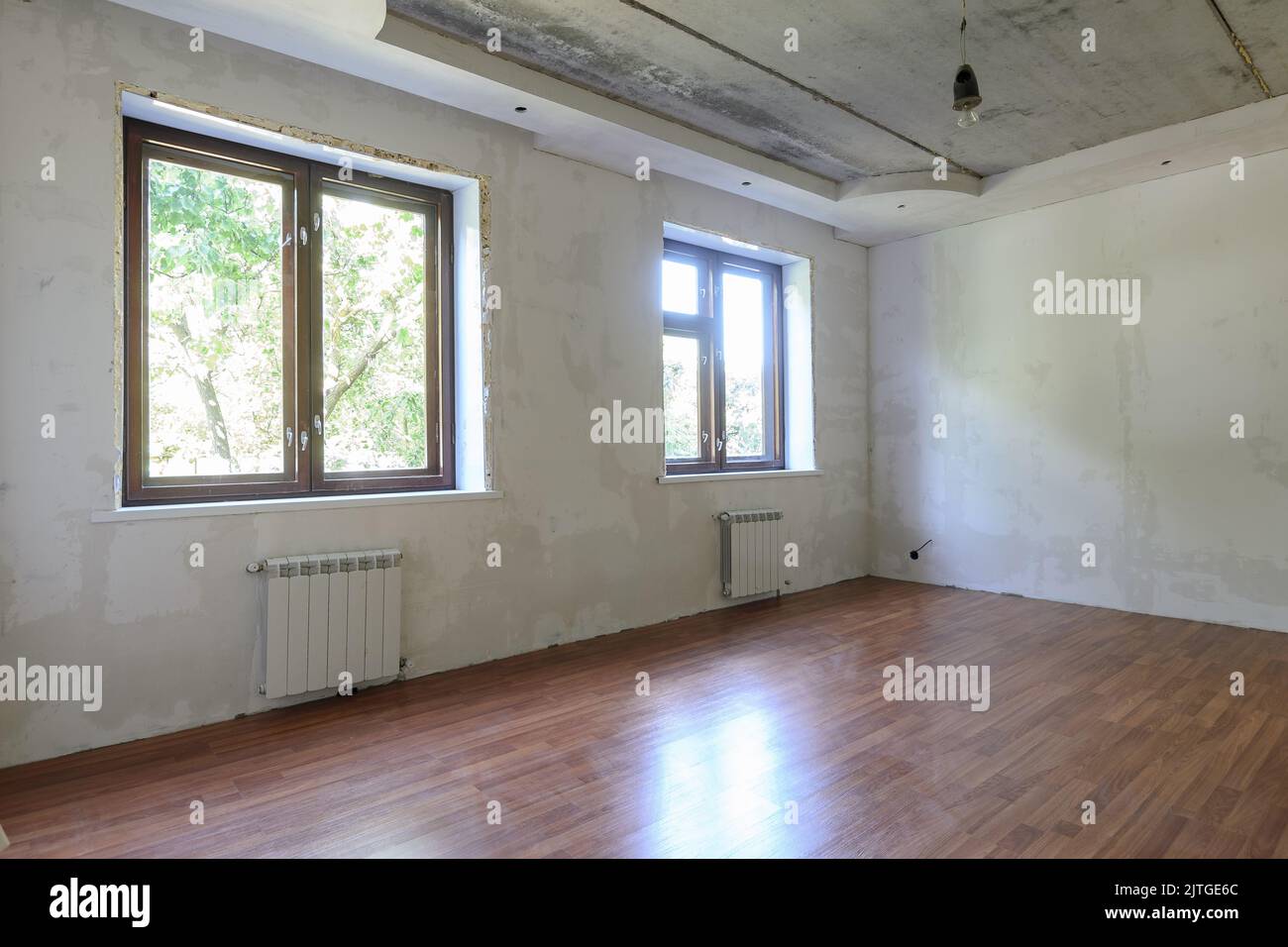 The interior of an empty room during renovation, there are two large ...