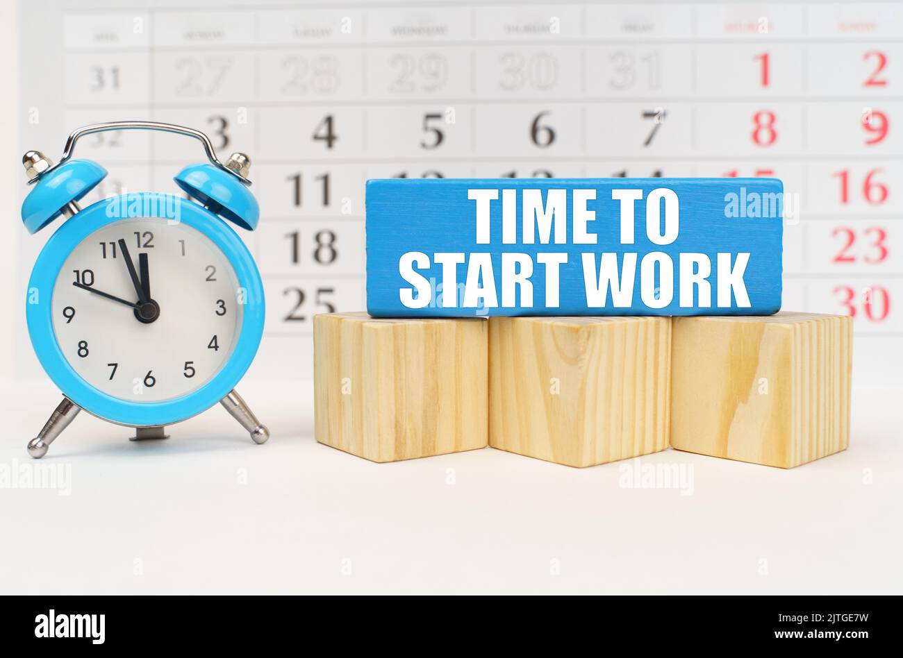 Time concept. Against the background of the calendar is an alarm clock