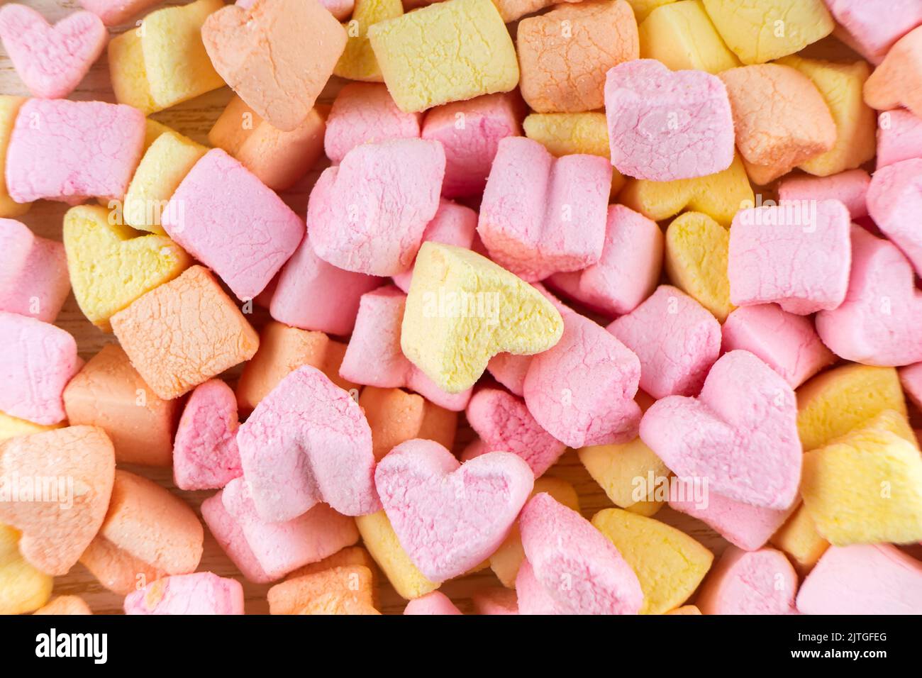 pink and yellow heart shape mini marshmallows textures. marshmallows