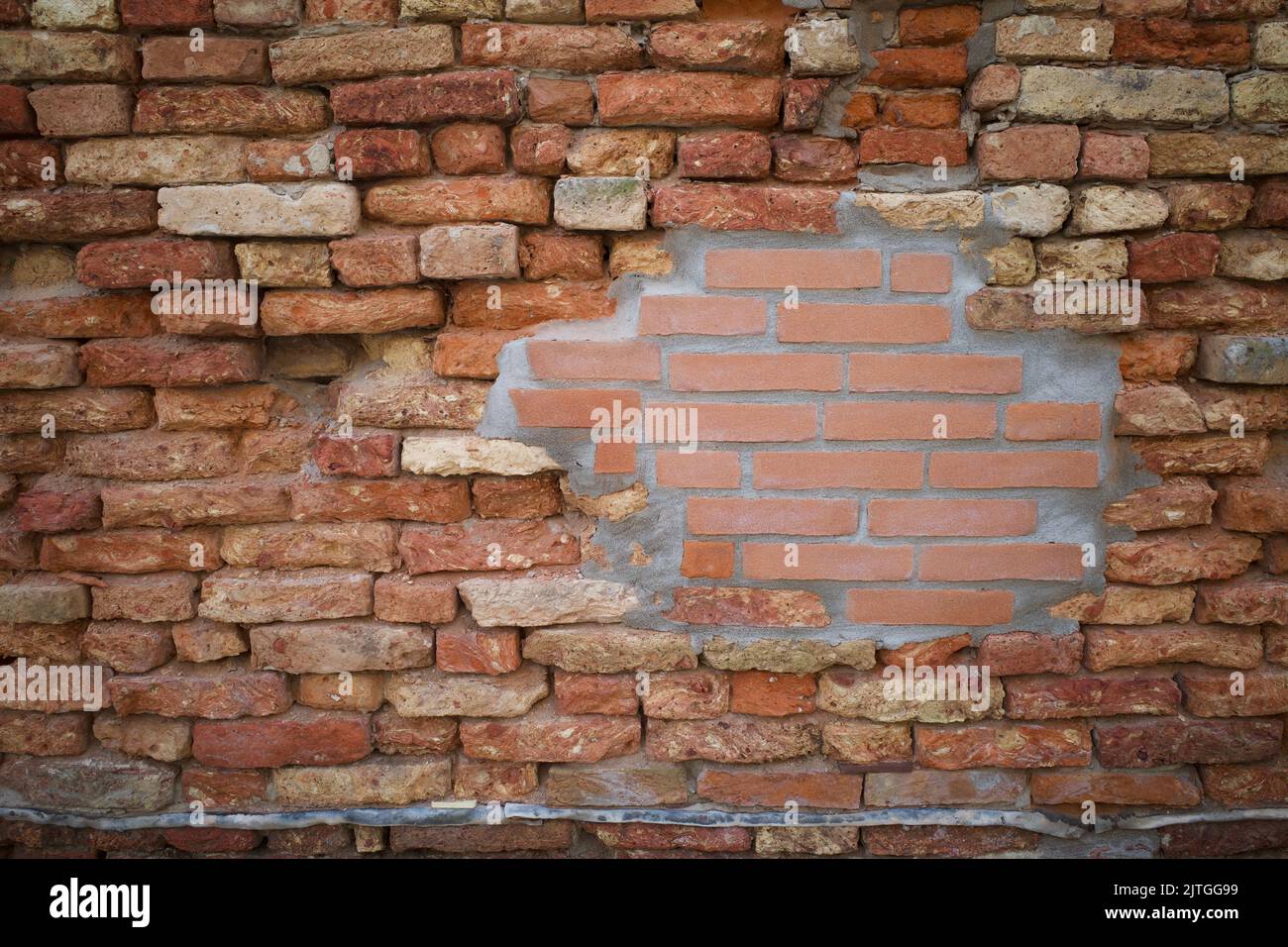 A wall that mixed with old and new materials Stock Photo