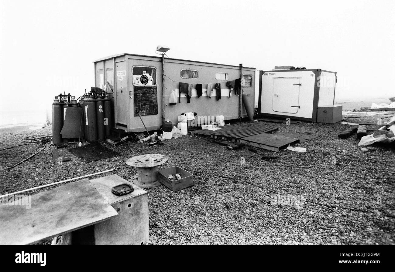 AJAXNETPHOTO. 28TH AUGUST, 1984. BULVERHYTHE BAY, NR HASTINGS, ENGLAND.  - AMSTERDAM WRECK - DIVERS WORKING FROM A PORTACABIN NEAR THE WRECKSITE HAVE INSPECTED THE TIMBERS OF THE 18TH CENTURY DUTCH EAST INDIA CO., MERCHANT SHIP. SHIP WAS WRECKED IN A CHANNEL STORM ON 26TH JANUARY, 1749 AND REDISCOVERED IN 1969.  PHOTO:JONATHAN EASTLAND/AJAX.  REF:340 220105 20 Stock Photo