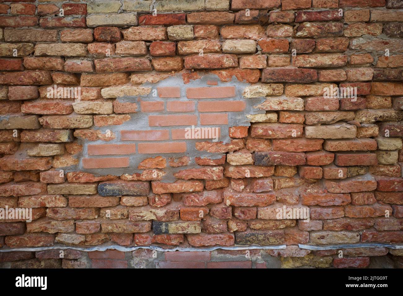 A wall that mixed with old and new materials Stock Photo