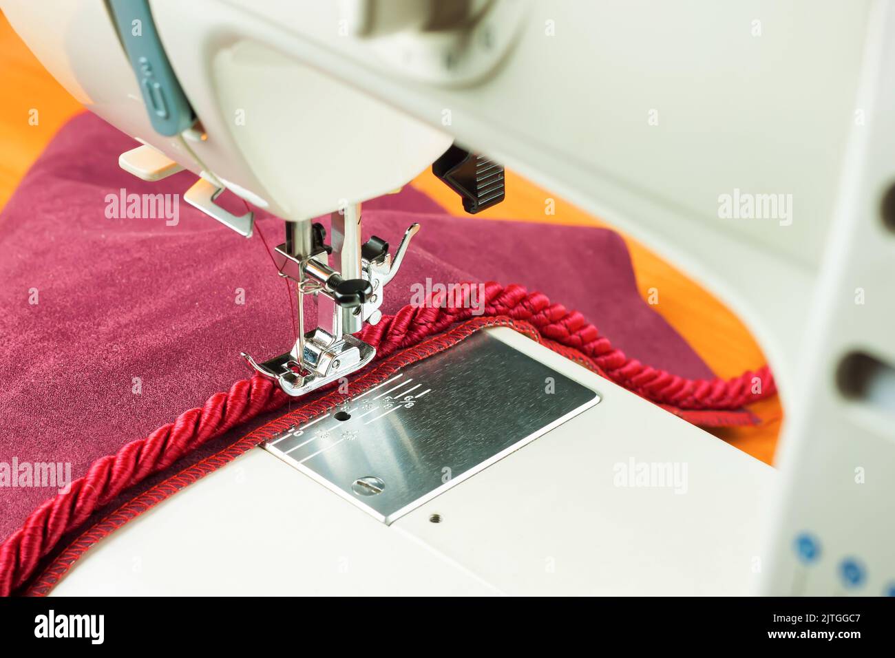 sewing machine needle and decorative edging cord. seiwng process Stock ...