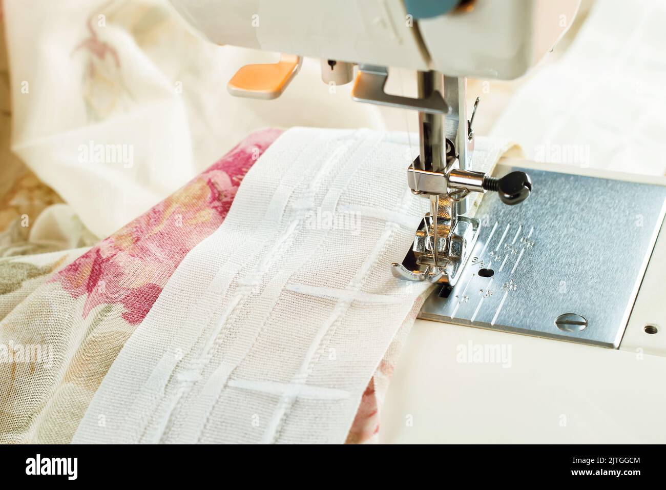 Modern sewing machine presser foot and colofrul cloth. Sewing process