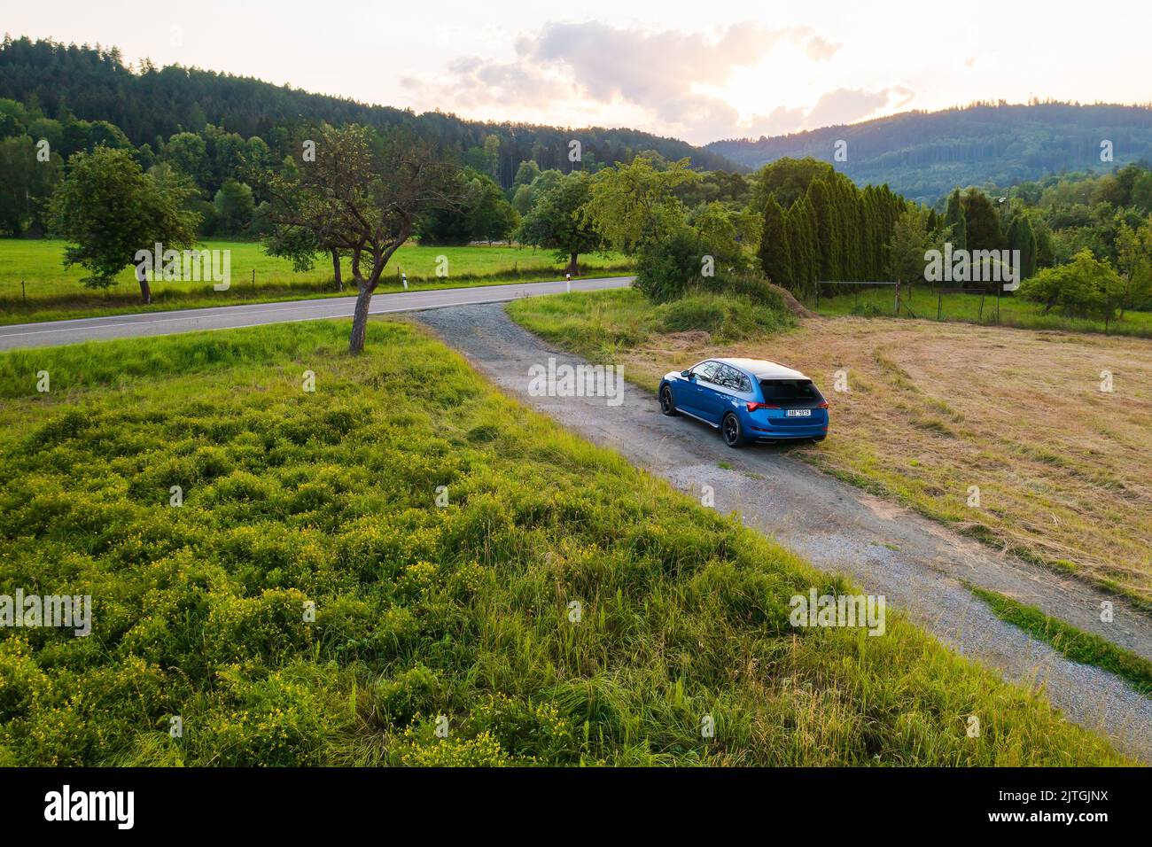 Off road traveling in blue Skoda Scala car at countryside road at sunset, August 2022, Dolni Morava, Czech Republic Stock Photo